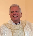 Portrait of Father Michael Ellis in white vestements
